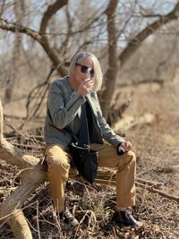 My mother, sitting on a fallen tree at my fathers celebration of life 