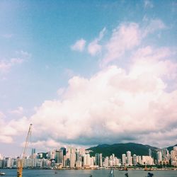 Cityscape against cloudy sky