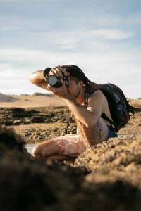 Man taking a photo in a beach