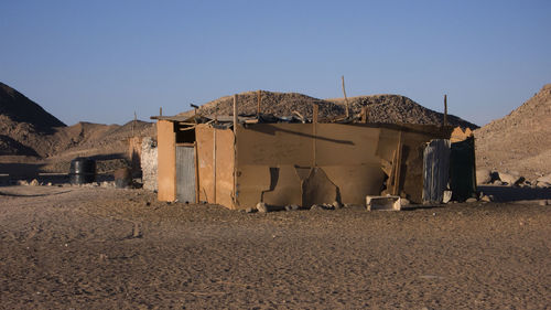 Exterior of abandoned building against clear sky
