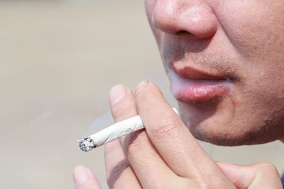 Close-up of man smoking cigarette