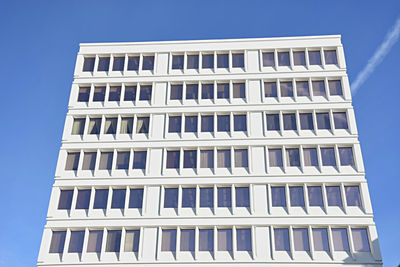 Low angle view of modern building against clear blue sky