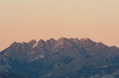 Scenic view of snowcapped mountains against clear sky