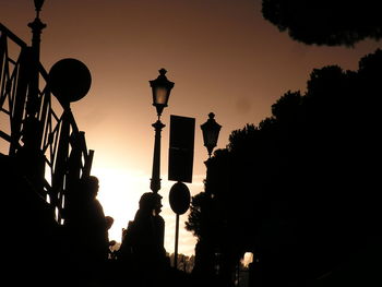 Low angle view of silhouette trees against sky