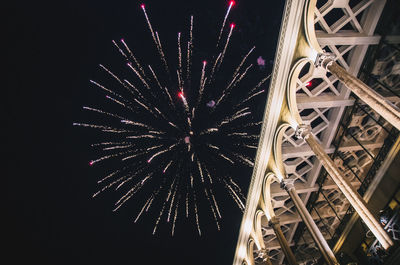 Low angle view of firework display at night