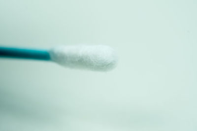 Close-up of blue glass against white background