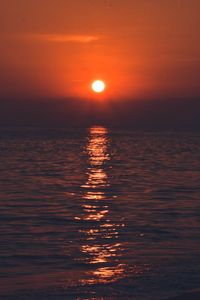 Scenic view of sea against romantic sky at sunset