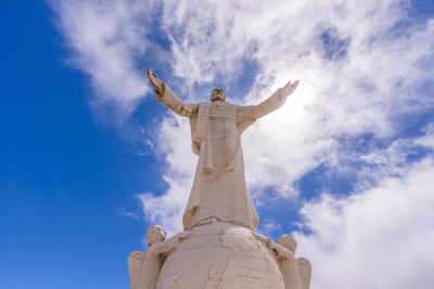 Low angle view of statue against cloudy sky