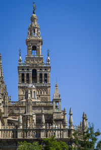 Low angle view of building against clear blue sky