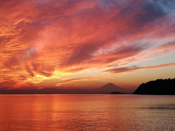 Scenic view of dramatic sky over sea during sunset