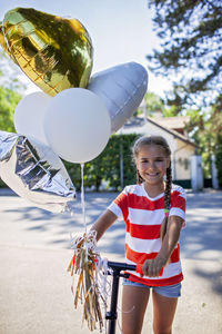 Portrait of smiling young woman standing on beach