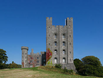 Low angle view of historic building against clear blue sky