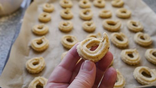 High angle view of hand holding christmas cookies