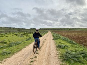 Riding an electric mountain bike along a dirt trail