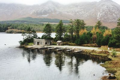 Scenic view of lake by trees and mountains