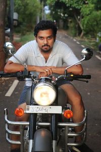 Portrait of young man riding motorcycle.