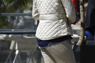 Midsection of woman standing in city