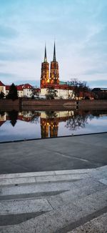 View of illuminated building against cloudy sky