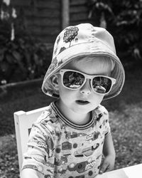 Portrait of cute boy wearing sunglasses outdoors