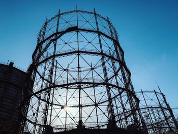 Low angle view of water tower against clear blue sky