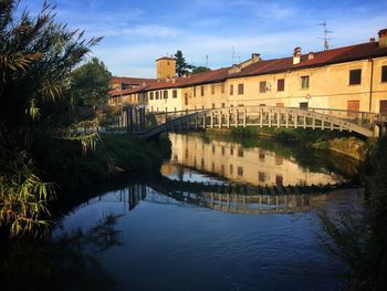 Bridge over river with buildings in background