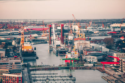 High angle view of commercial dock by sea against sky