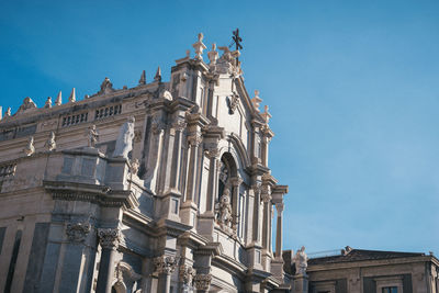 Low angle view of historical building against clear blue sky