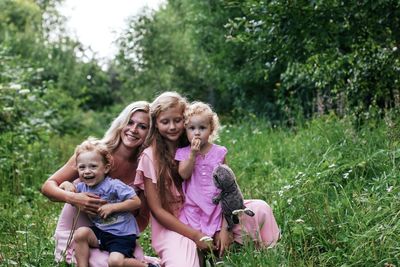 Portrait of a smiling family against plants