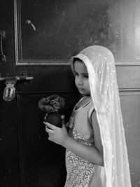 Low section of woman standing against door