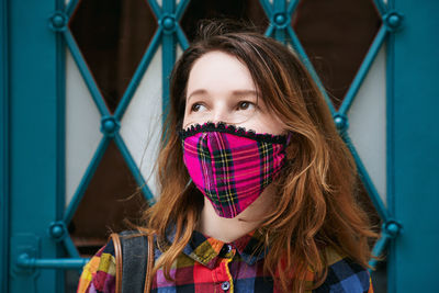 Portrait of young woman wearing mask