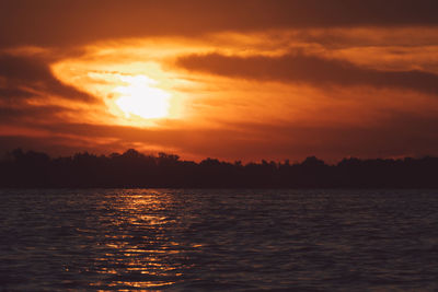 Scenic view of sea against romantic sky at sunset