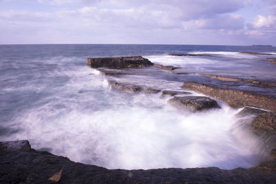 Scenic view of sea against cloudy sky