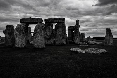 Rock formations on field against sky