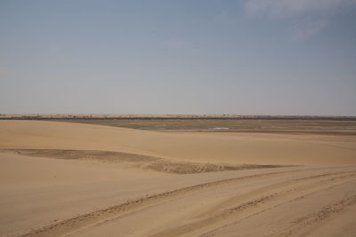 Scenic view of landscape at namib desert against sky