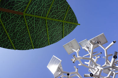 Low angle view of traditional windmill against clear blue sky