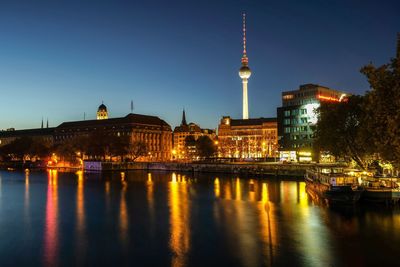 Illuminated city at waterfront