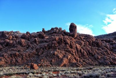 Low angle view of rock formation against clear blue sky