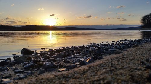 Scenic view of river at sunset