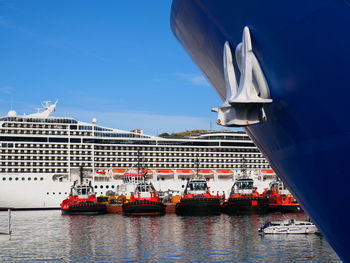 The port with  ships and tugs