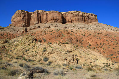 Sandy-clay bastions of the temirlik canyon, relief red-yellow high cliffs on the top of the mountain