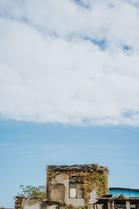 Low angle view of old building against cloudy sky