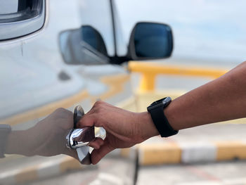 Close-up of hand holding a car