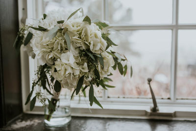 Close-up of white flower vase on table at home