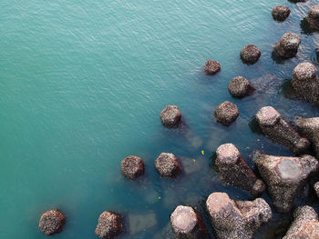 High angle view of rocks in sea