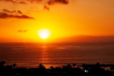 Scenic view of sea against romantic sky at sunset