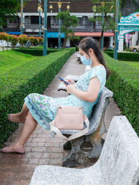 An asian woman reading long-recorded messages on her mobile phone reminds me of the past.