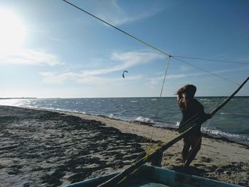 Woman on beach against sky