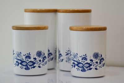 Close-up of coffee cup on table against wall