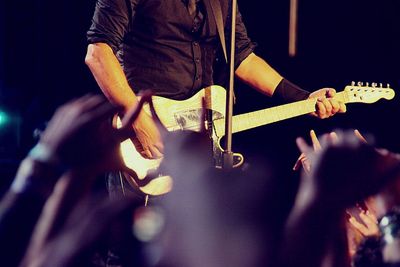 Cropped image of woman playing guitar