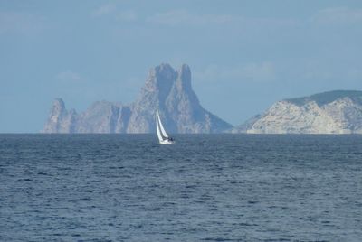 Sailboat in sea against sky